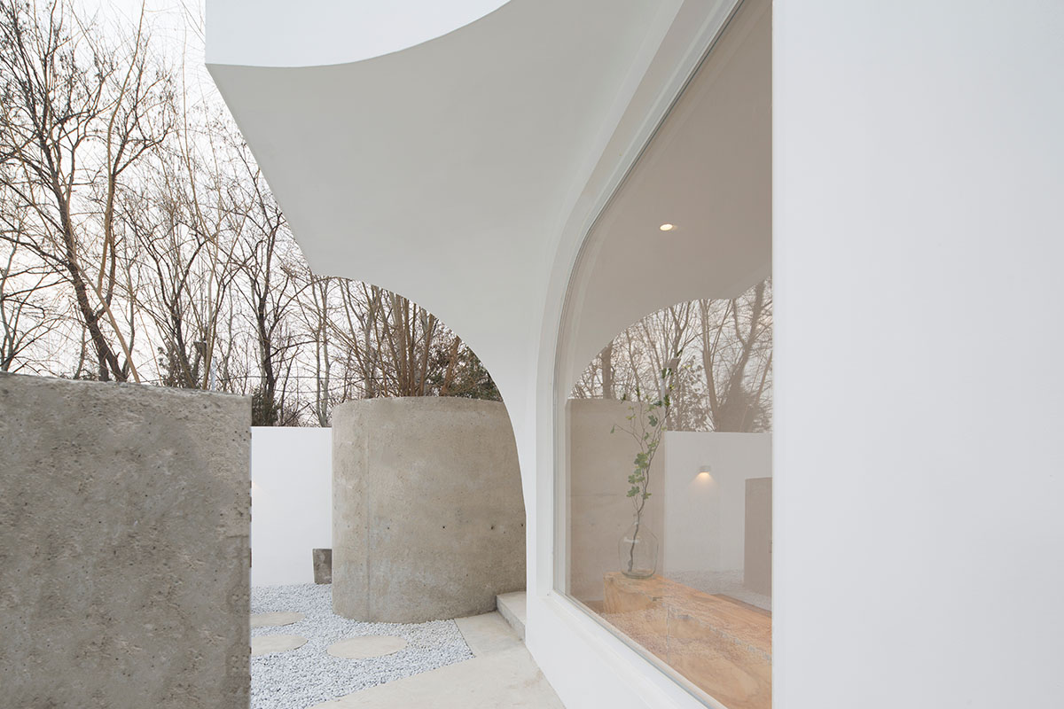 Boutique hotel by Atelier d'More is shaped by flowing curves and sculptural geometric compositions