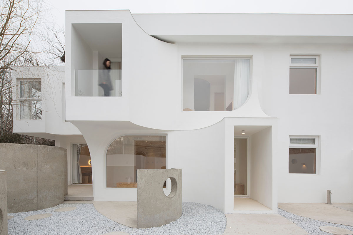 Boutique hotel by Atelier d'More is shaped by flowing curves and sculptural geometric compositions