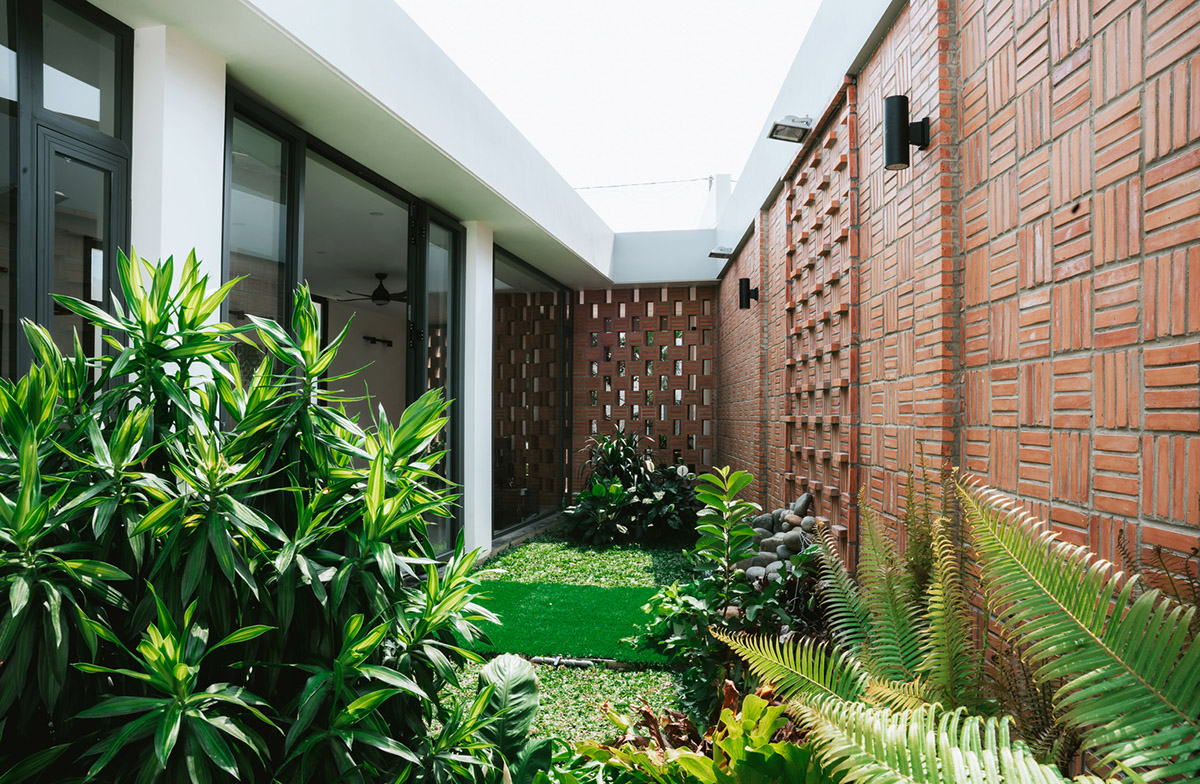 90odesign built this small house with brick walls as a shield of the house in Ho Chi Minh city