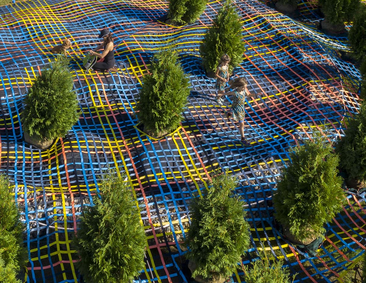 SO-IL wraps living trees with a hand-made nylon webbing in Columbus