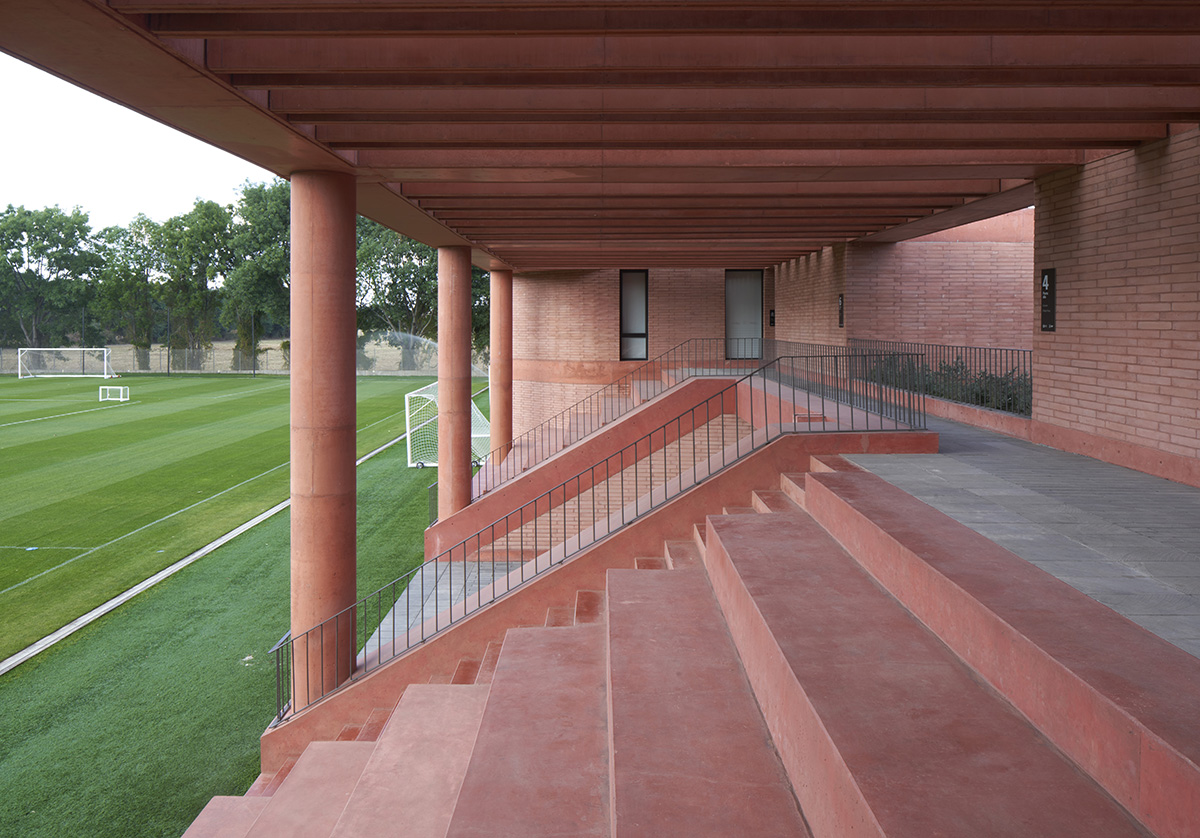 Red pigmented gridded structure defines village-like Mexican sport facility by Sordo Madaleno