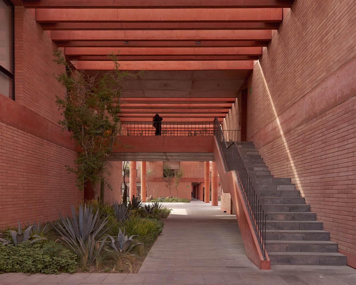 Red pigmented gridded structure defines village-like Mexican sport facility by Sordo Madaleno