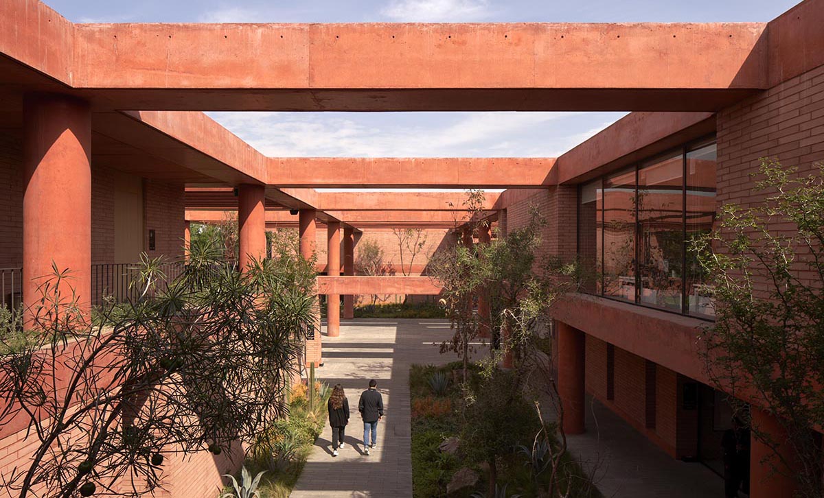 Red pigmented gridded structure defines village-like Mexican sport facility by Sordo Madaleno