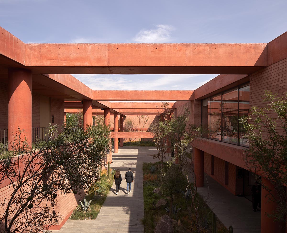 Red pigmented gridded structure defines village-like Mexican sport facility by Sordo Madaleno