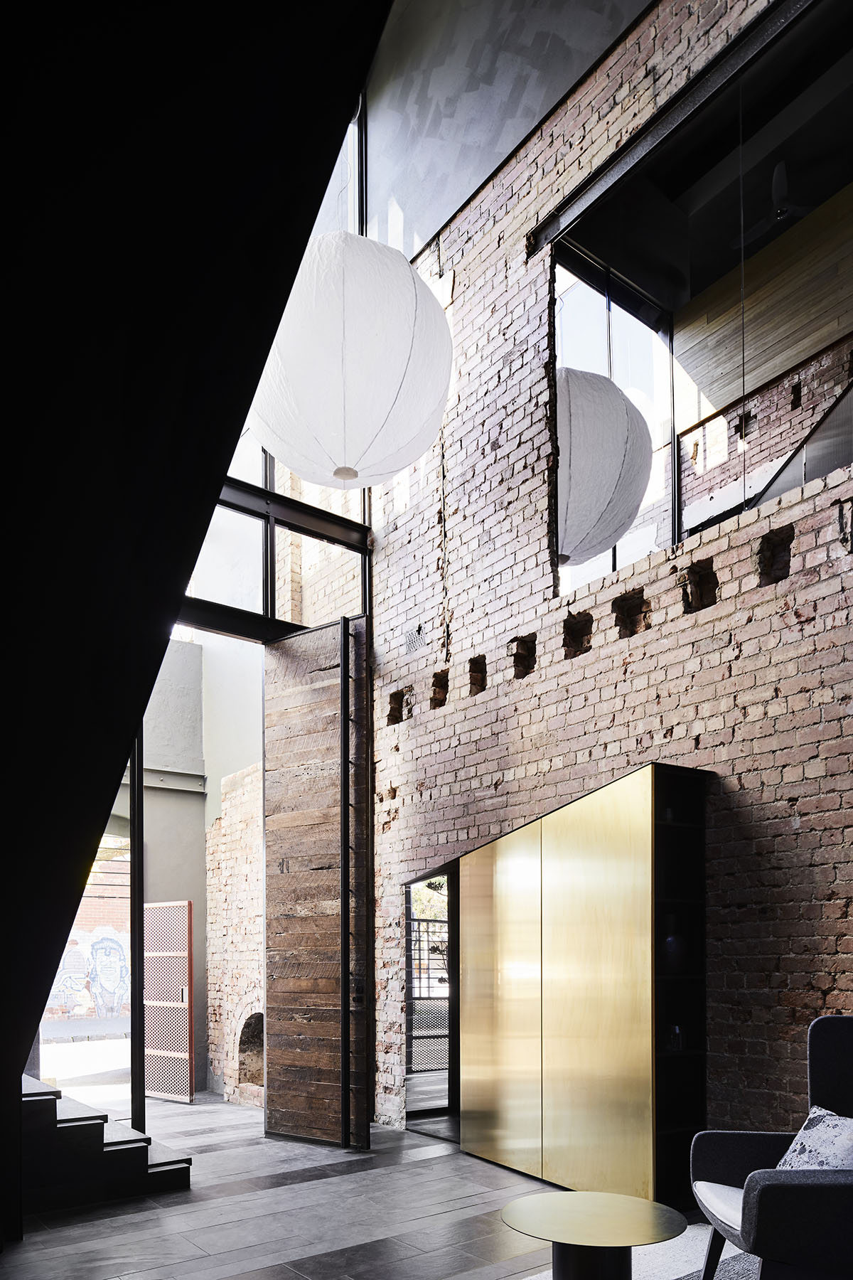Splinter Society Architecture transforms old warehouse into a dark and moody home in Melbourne