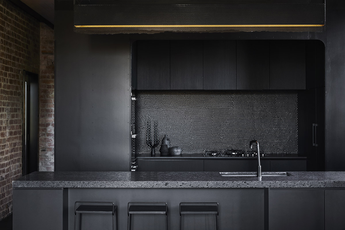Splinter Society Architecture transforms old warehouse into a dark and moody home in Melbourne