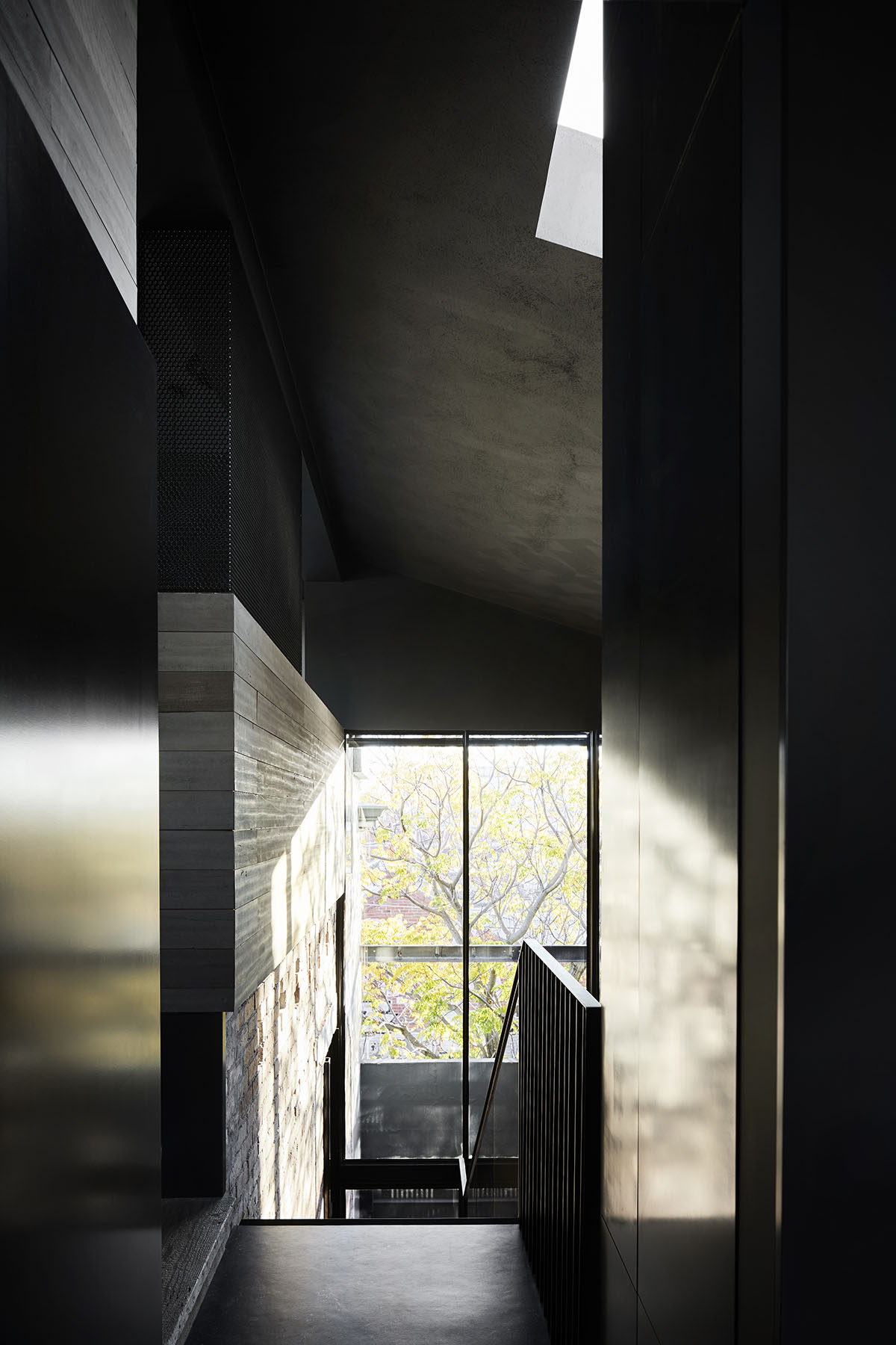 Splinter Society Architecture transforms old warehouse into a dark and moody home in Melbourne