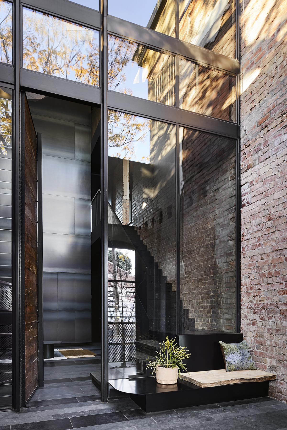 Splinter Society Architecture transforms old warehouse into a dark and moody home in Melbourne