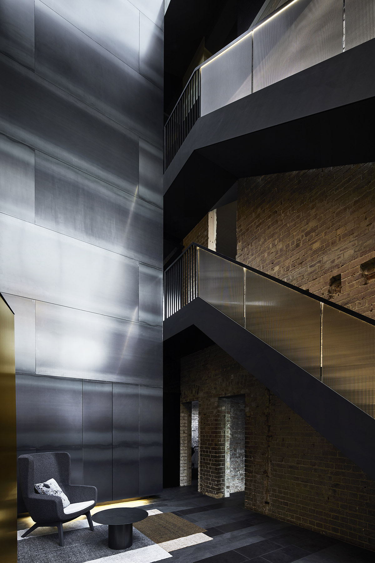 Splinter Society Architecture transforms old warehouse into a dark and moody home in Melbourne