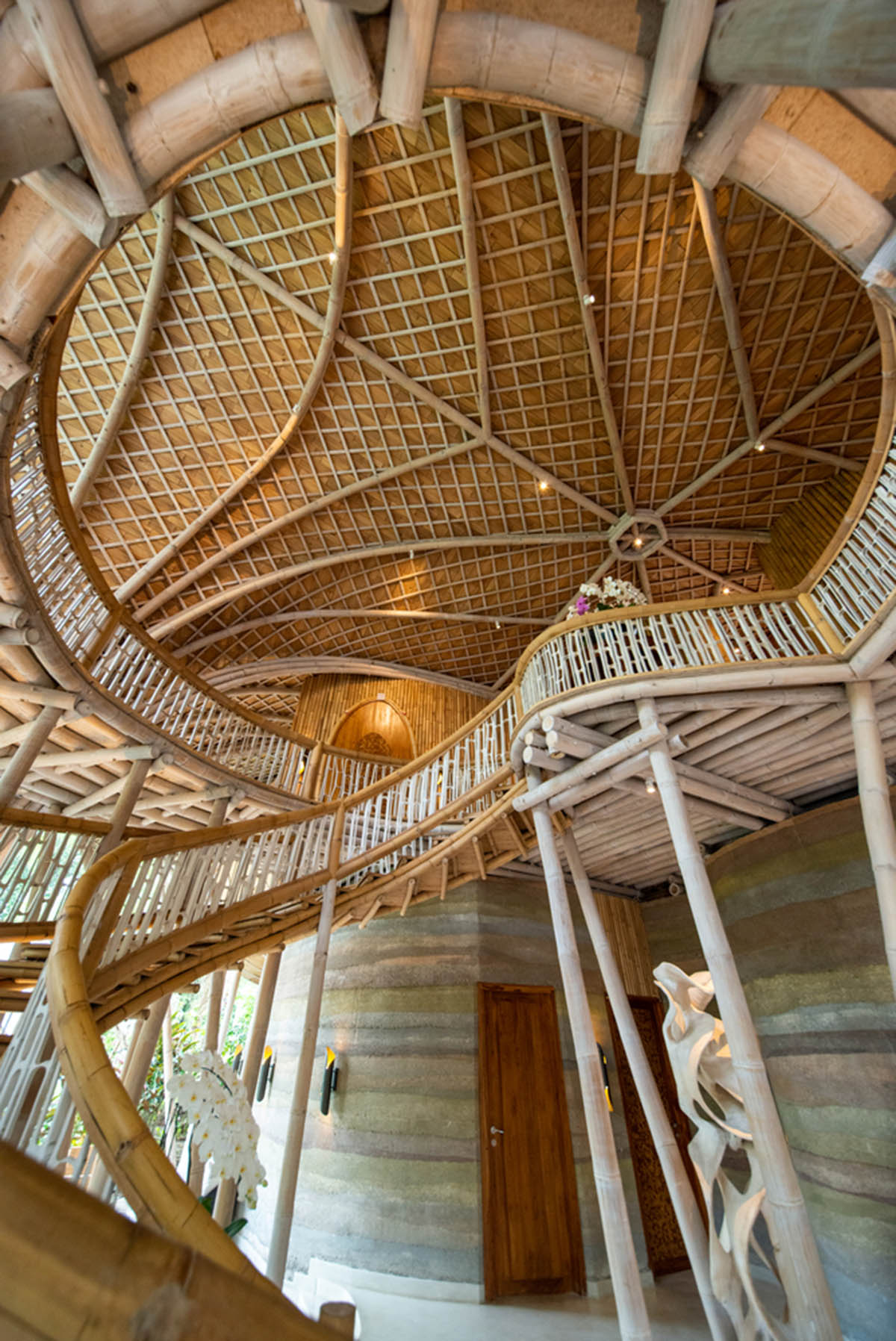 Undulating bamboo roofs wrap this wellness retreat in a lush forest of Bali