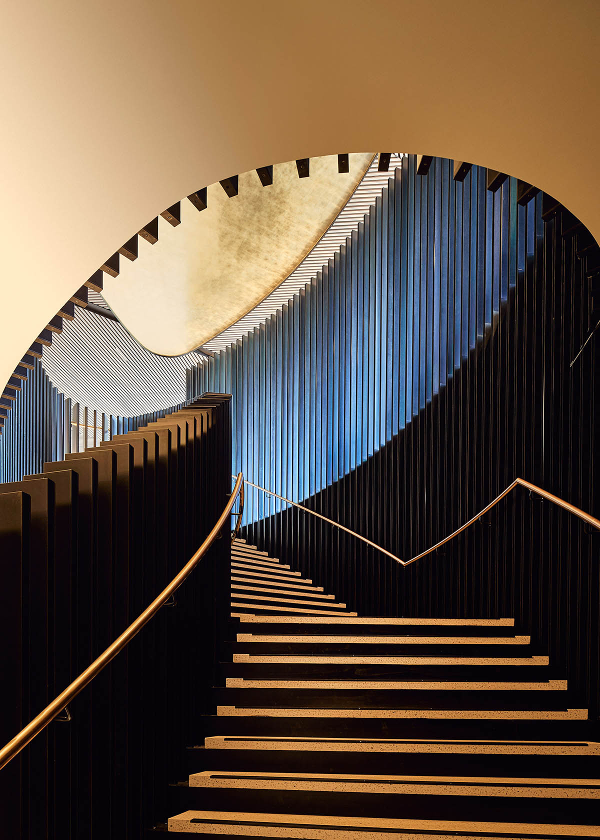 Wood Marsh completes sinuous resort anchored on hand-built locally sourced stone plinth in Australia