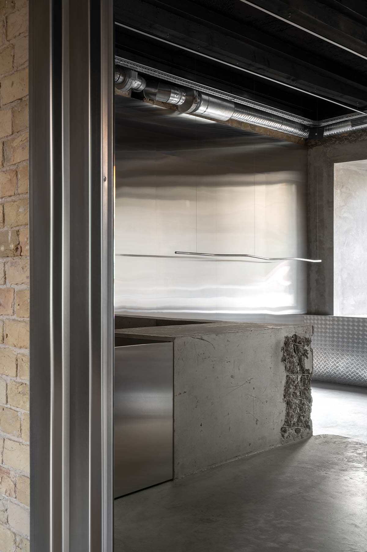 An early 20th-century building is transformed into a raw, industrial-looking interior for Kyiv store 