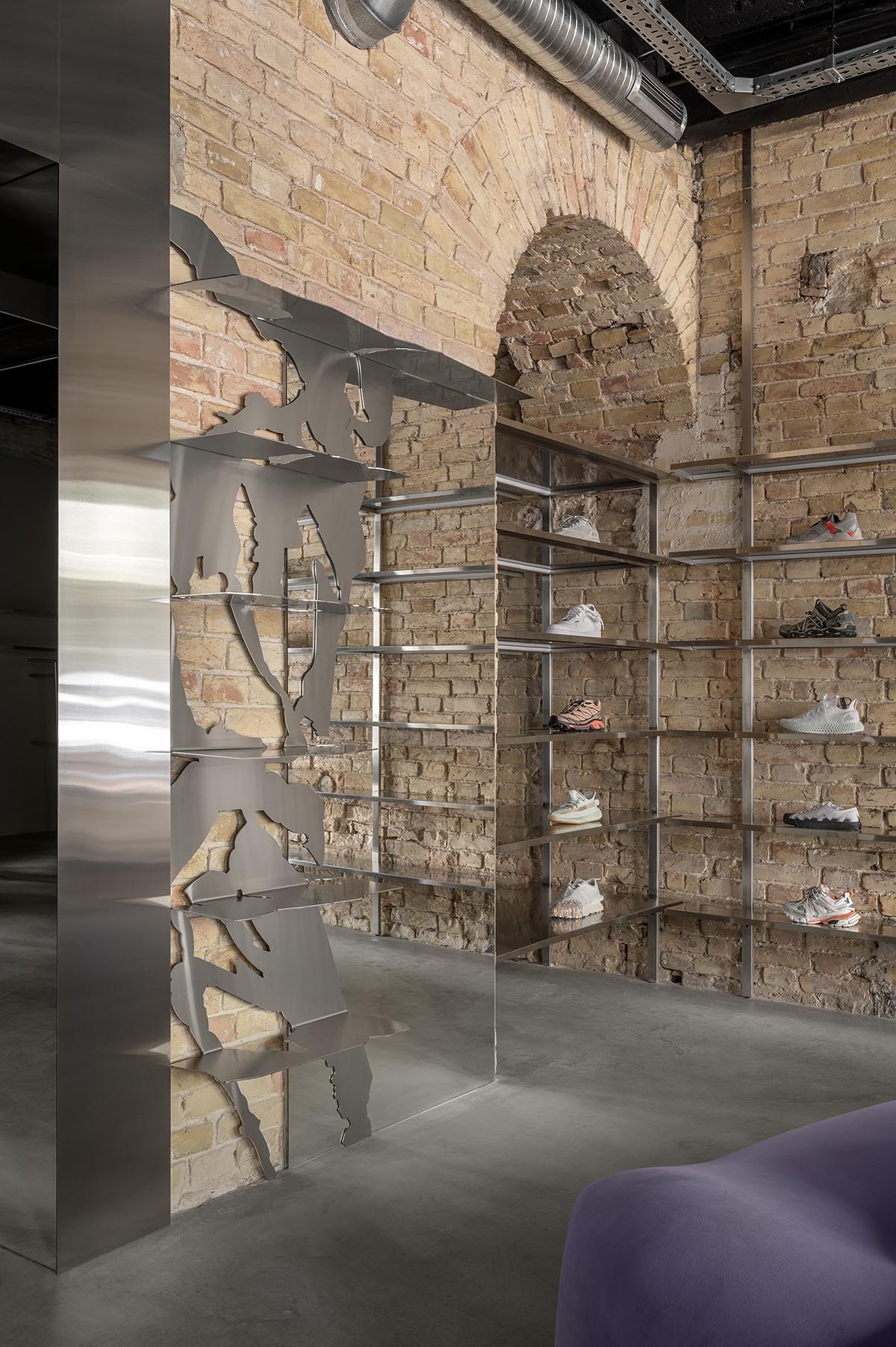 An early 20th-century building is transformed into a raw, industrial-looking interior for Kyiv store 