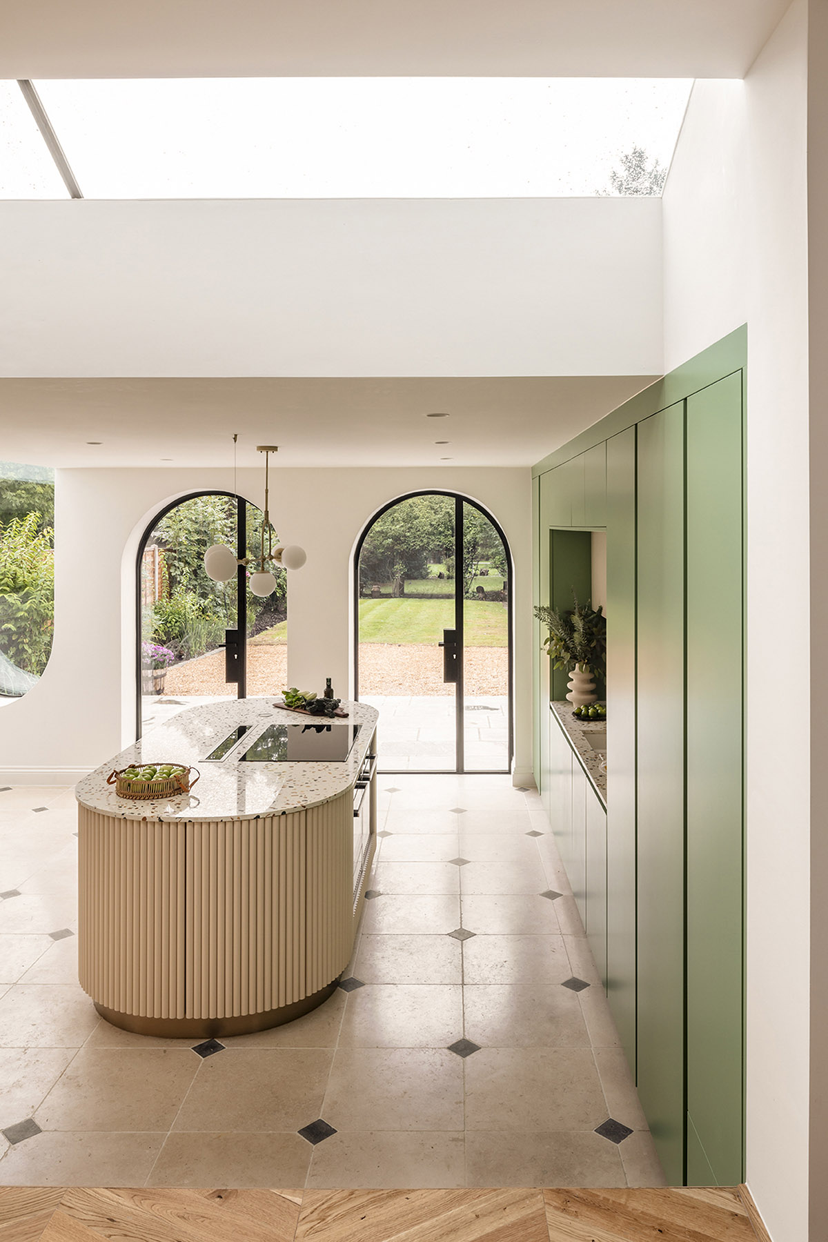 Studio Jayga Architects creates greenish and powder-colored interiors featuring arched doors in Essex