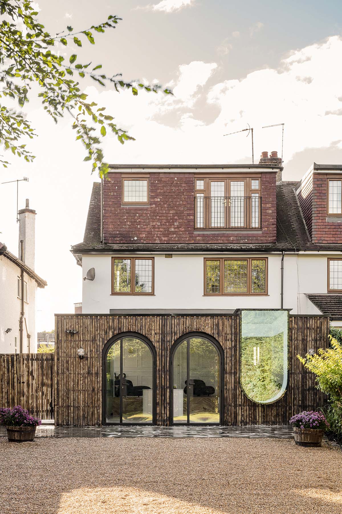 Studio Jayga Architects creates greenish and powder-colored interiors featuring arched doors in Essex