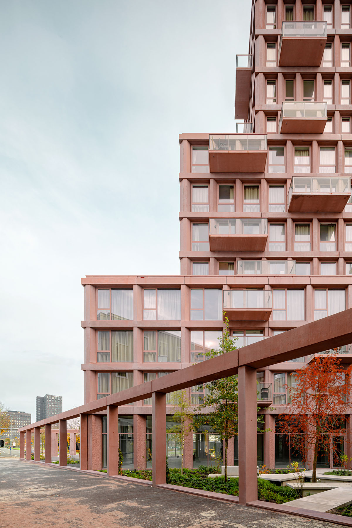Studioninedots built soft red concrete residential tower in Almere