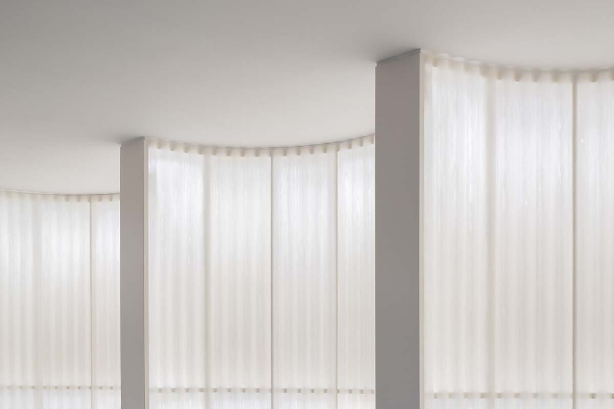 A beauty salon brings warm light with translucent partitions and tactile elements in Prague