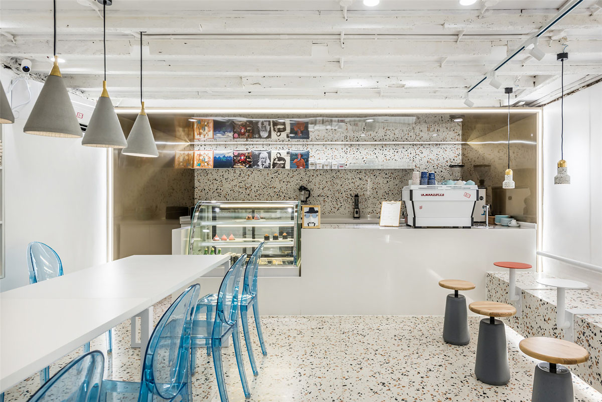 This tiny cafe by TOUCH Design is dotted with white and orange interwoven terrazzo details in Tianjin