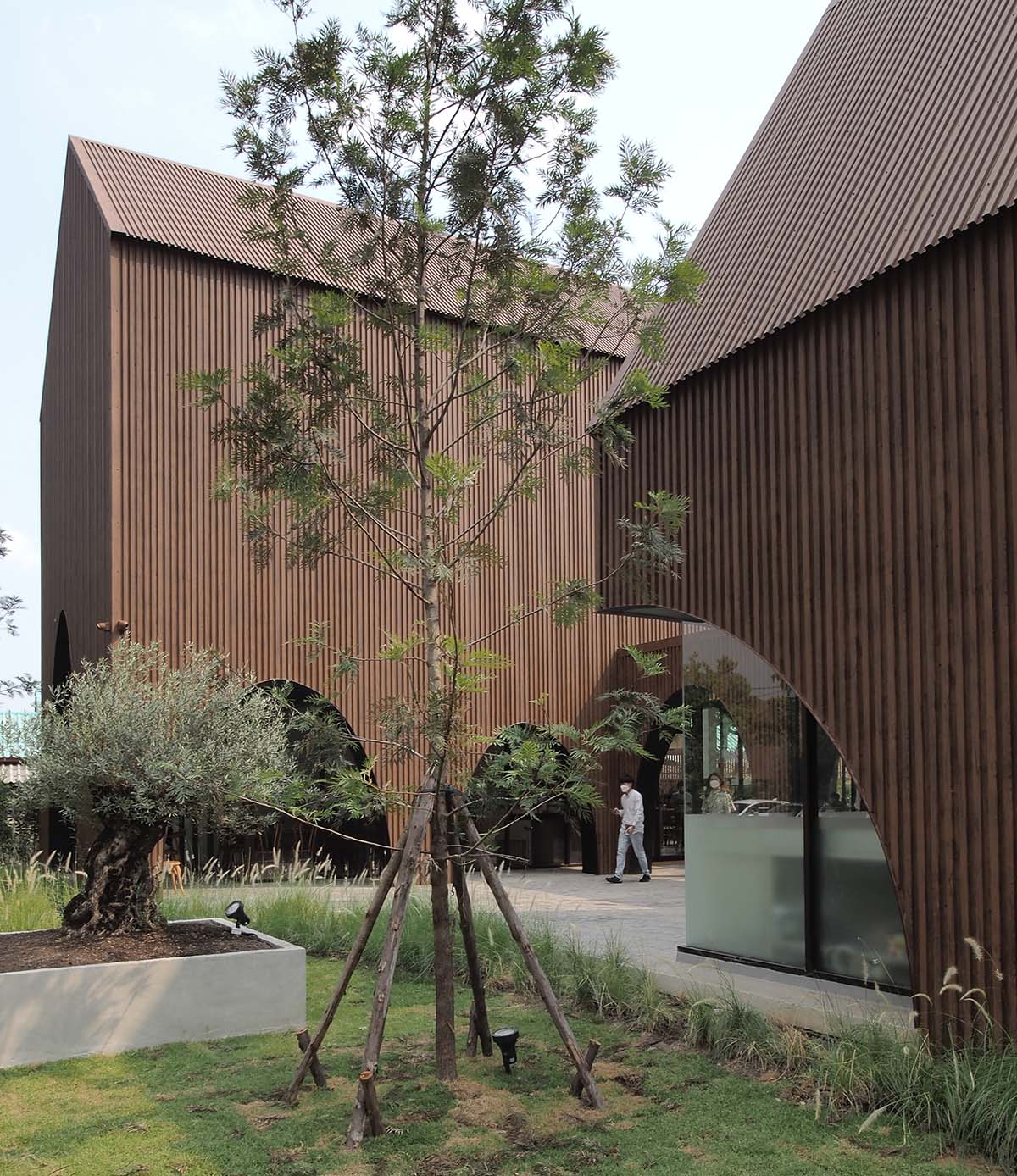 spacy architecture wraps serene bangkok cafe in floating glass