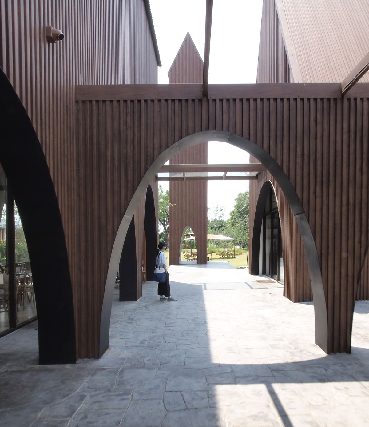 ASWA wraps barn-looking restaurant and cafe complex with wood-like metal sheet in Bangkok