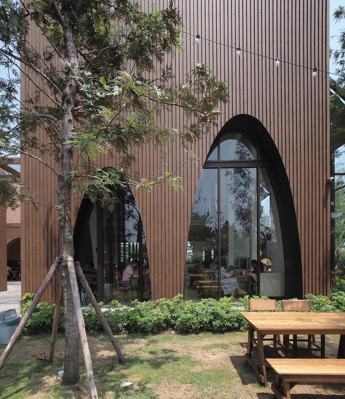 spacy architecture wraps serene bangkok cafe in floating glass