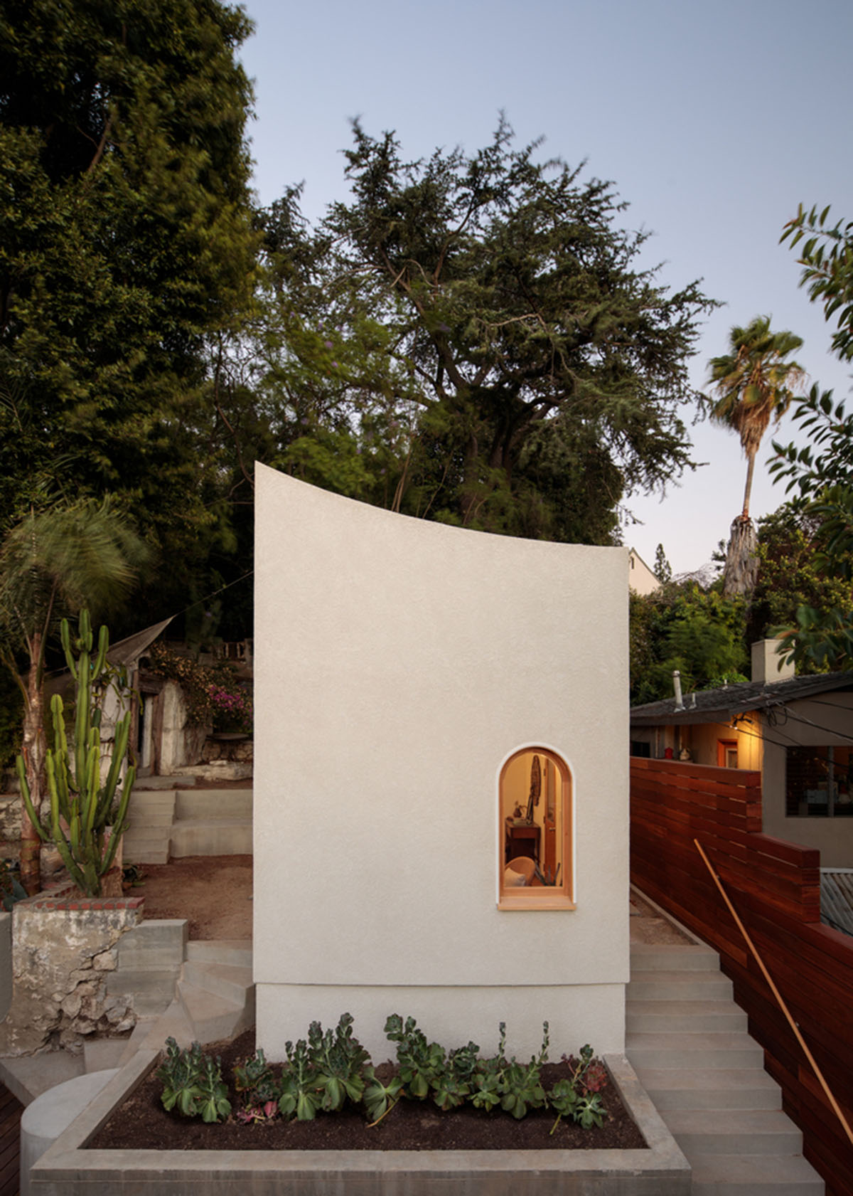 Filmmaker's writing studio is crowned with curved-profiled wall at the backyard of a house in LA