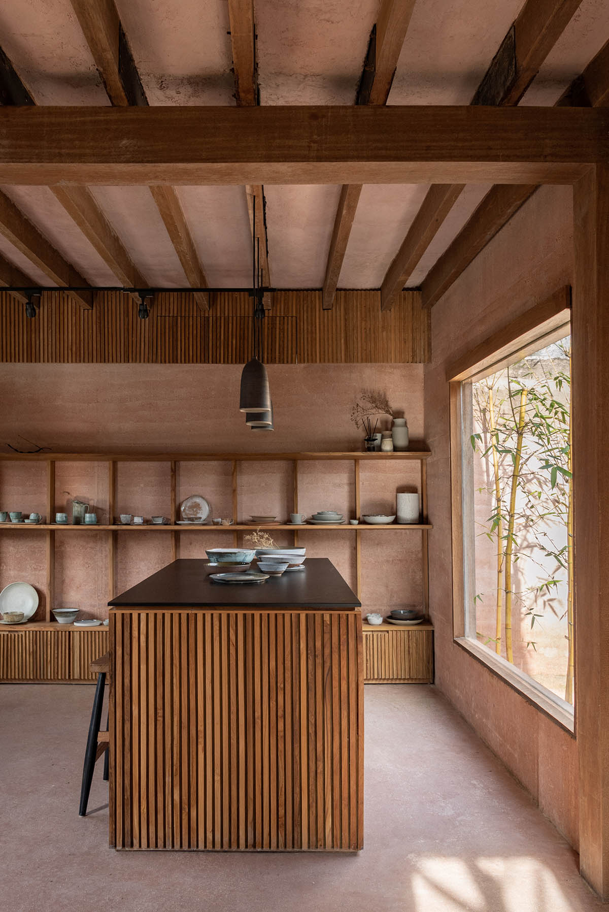 Blancostudio wraps pottery shop with rammed-earth walls with zen garden in Ubud 