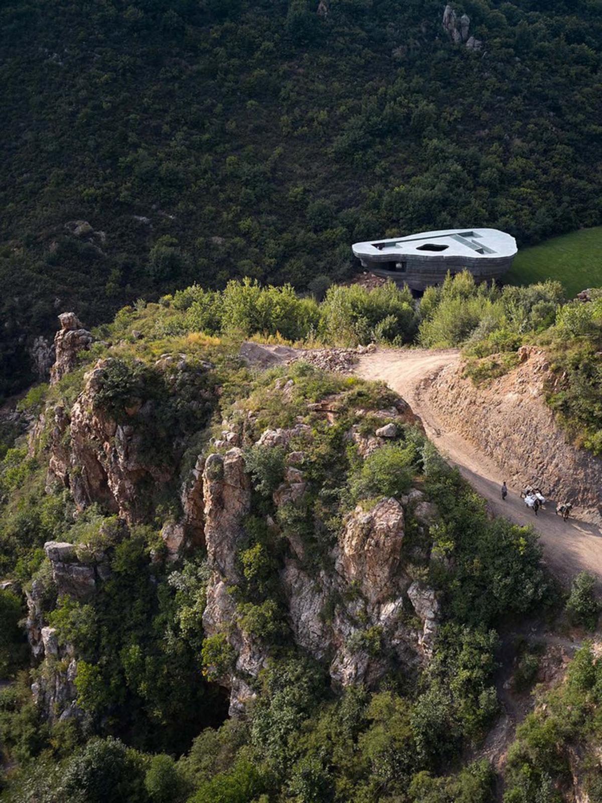 OPEN Architecture designs monolithic rock-like open-air concert hall in the north of Beijing