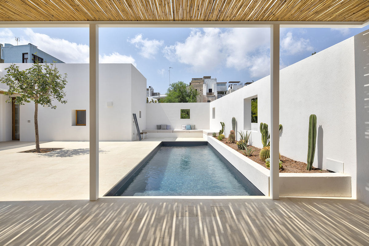 Dos Architects creates small patios with an interplay of all-white volumes for house in Salento