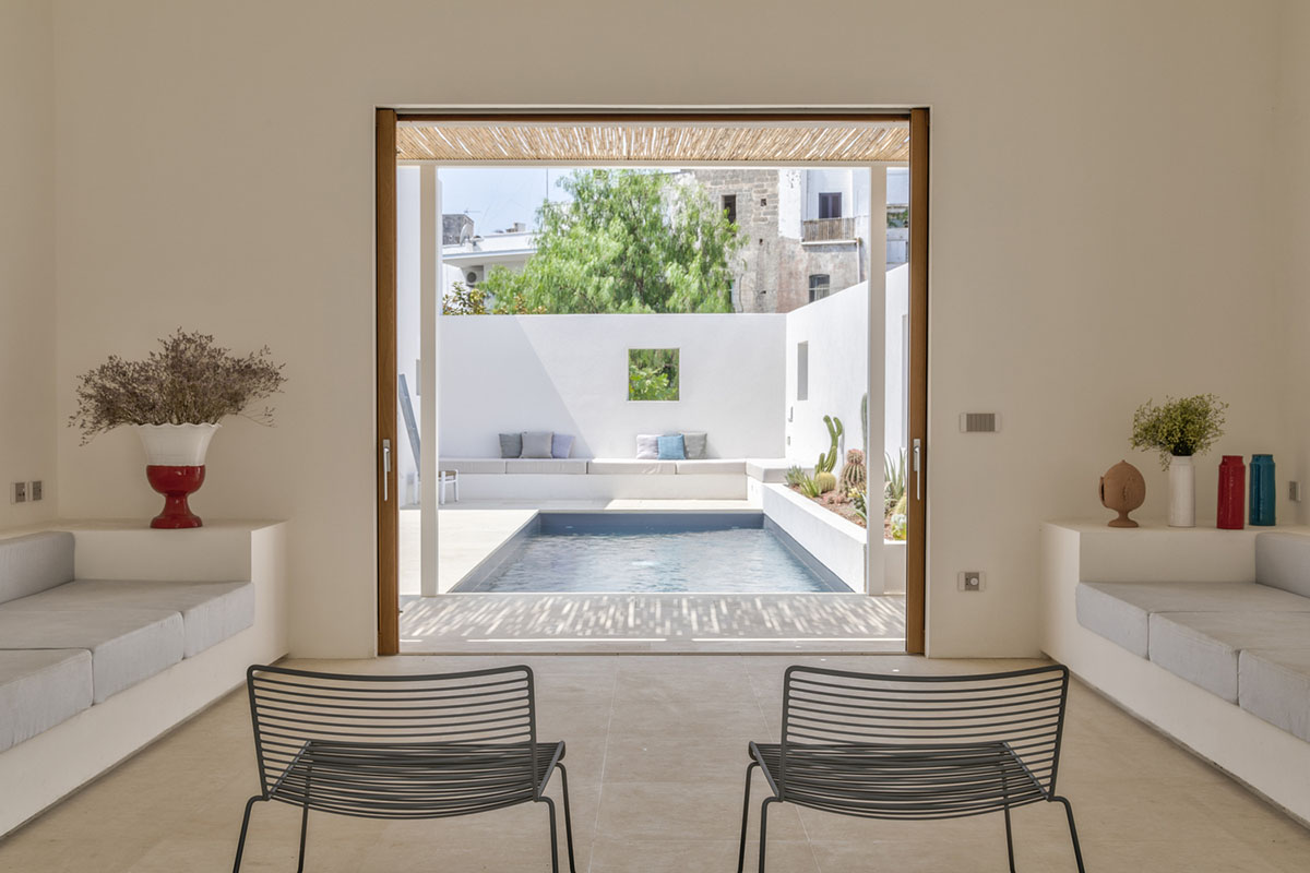 Dos Architects creates small patios with an interplay of all-white volumes for house in Salento