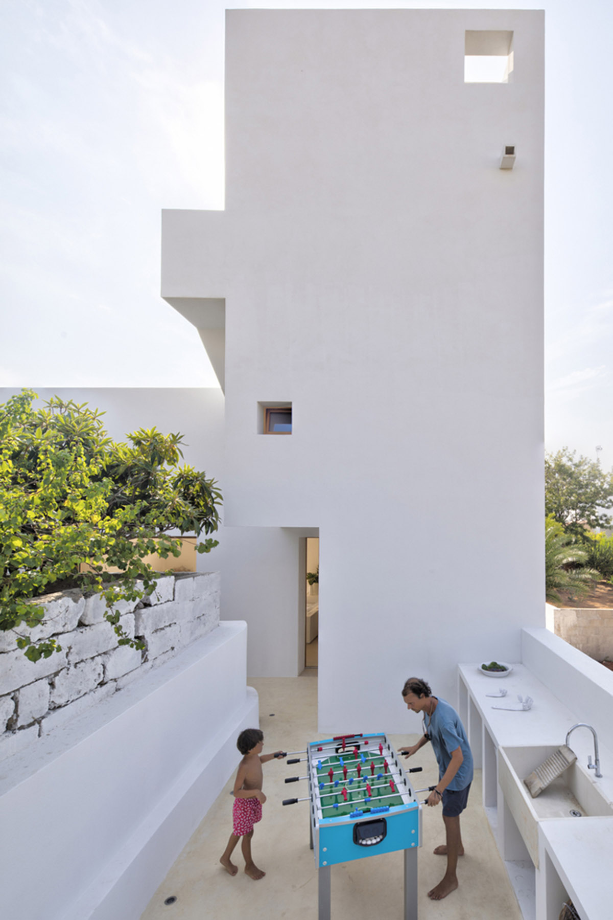Dos Architects creates small patios with an interplay of all-white volumes for house in Salento