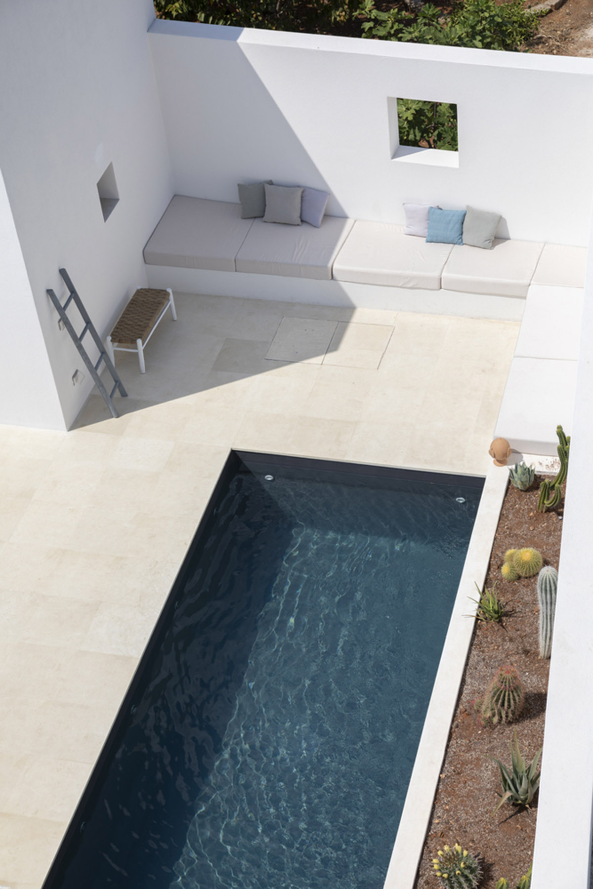 Dos Architects creates small patios with an interplay of all-white volumes for house in Salento