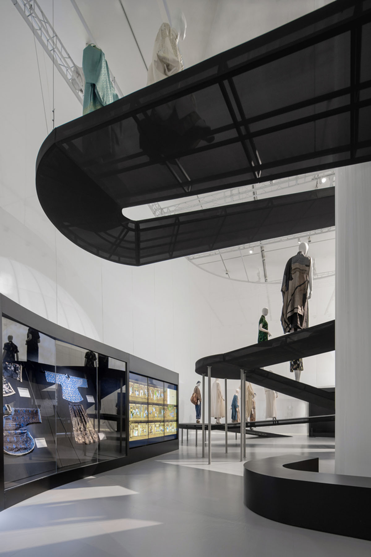 Studio 10 designs exhibition space with white tubular structures and black translucent ramps in China