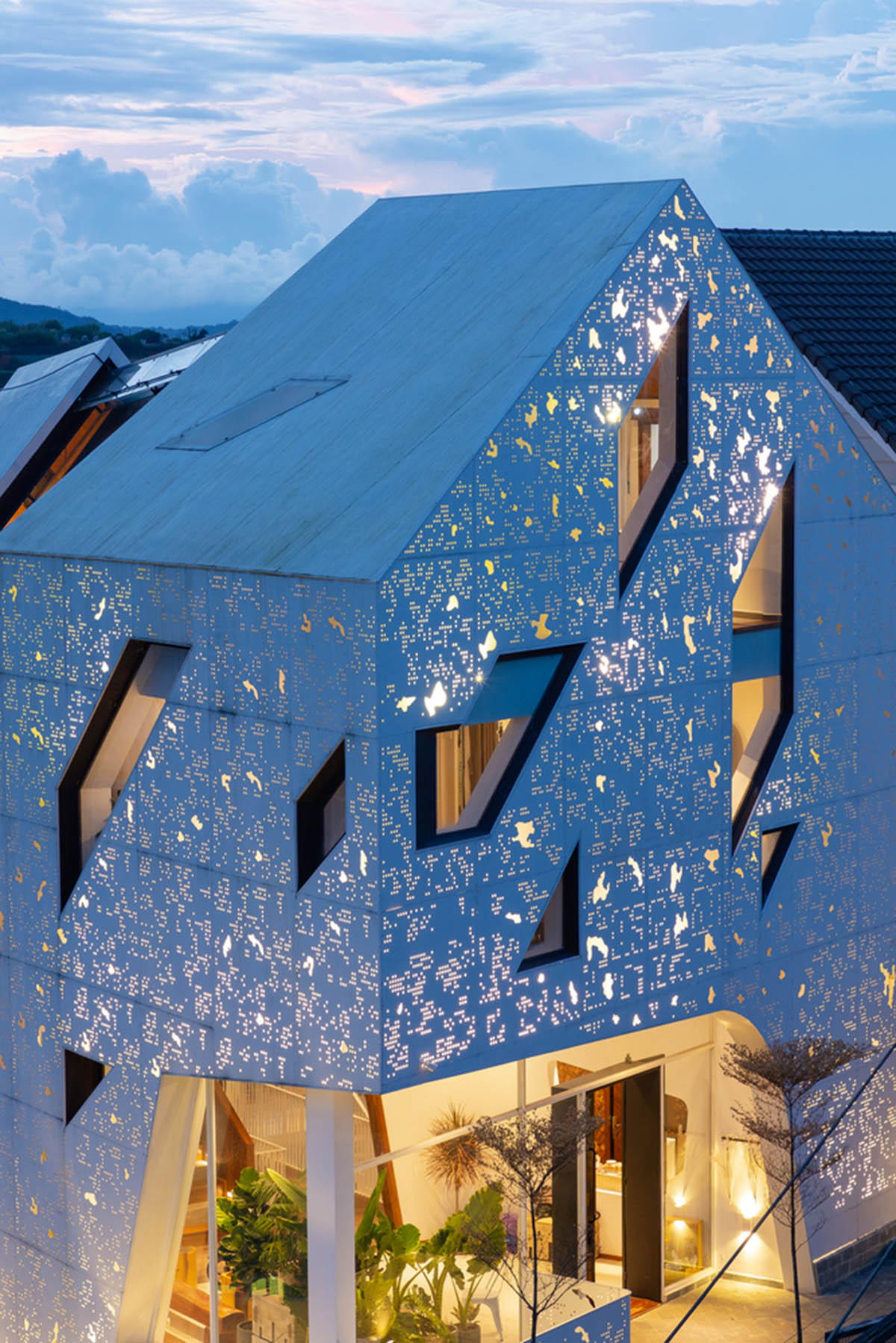 Le House wraps this small hotel with porous steel facade made of irregular patterns in Vietnam
