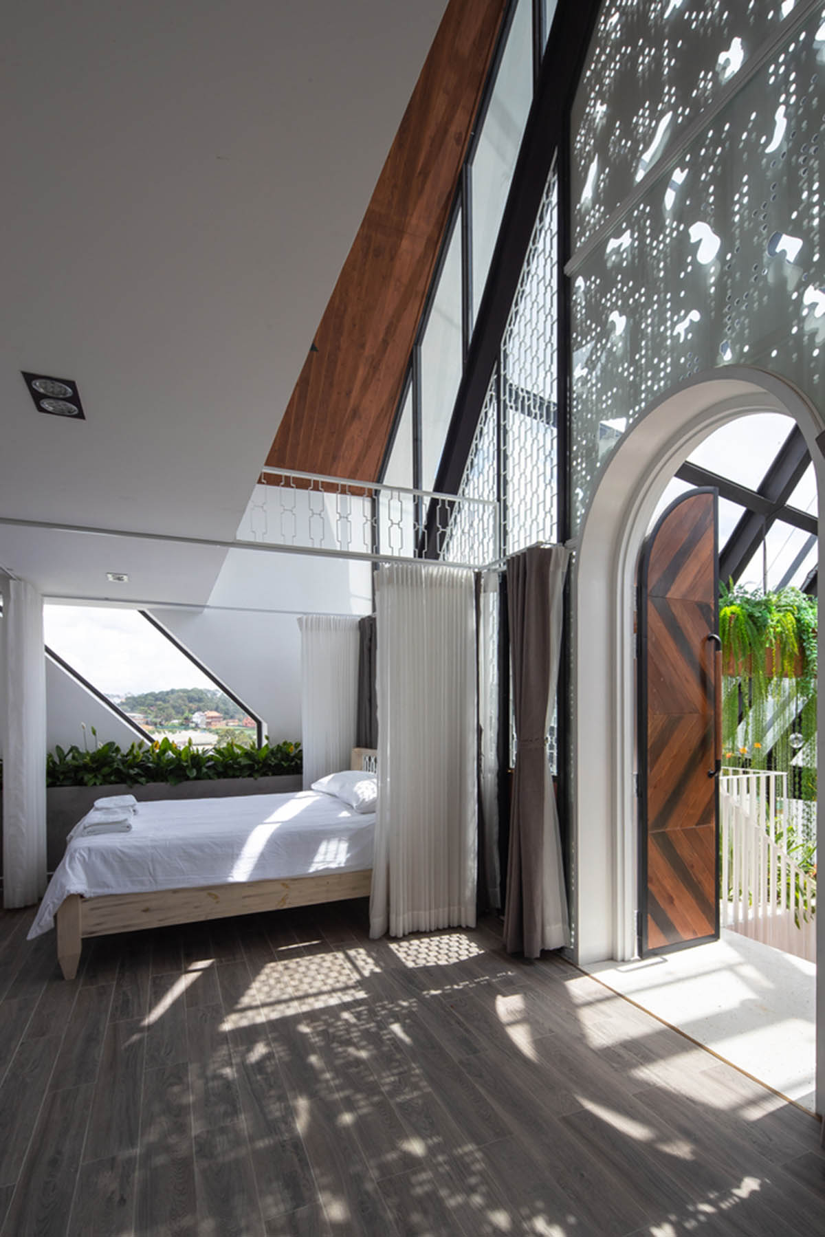 Le House wraps this small hotel with porous steel facade made of irregular patterns in Vietnam