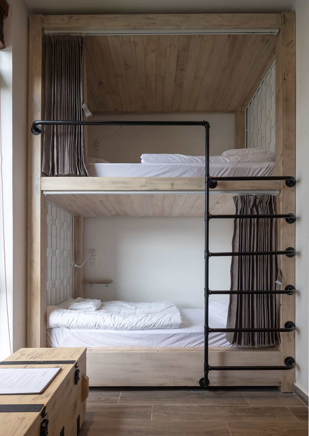 Le House wraps this small hotel with porous steel facade made of irregular patterns in Vietnam