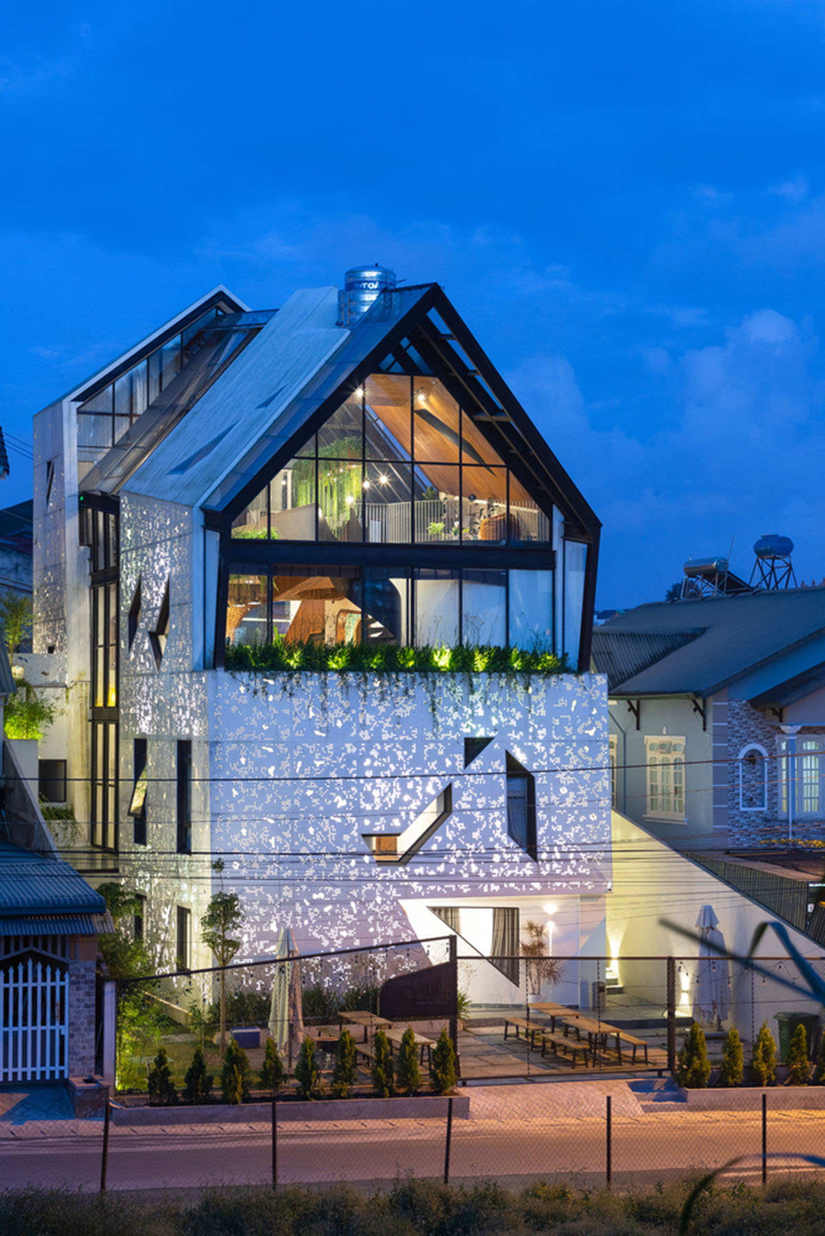 Le House wraps this small hotel with porous steel facade made of irregular patterns in Vietnam