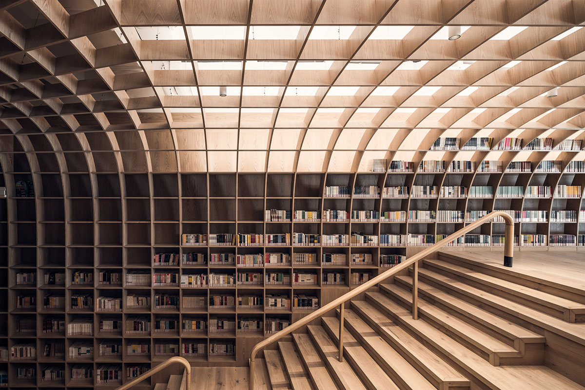Wutopia Lab wraps the interior of a neighborhood center with wood-like aluminum panels