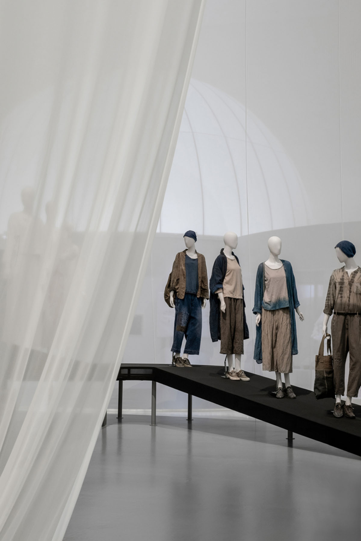 Studio 10 designs exhibition space with white tubular structures and black translucent ramps in China