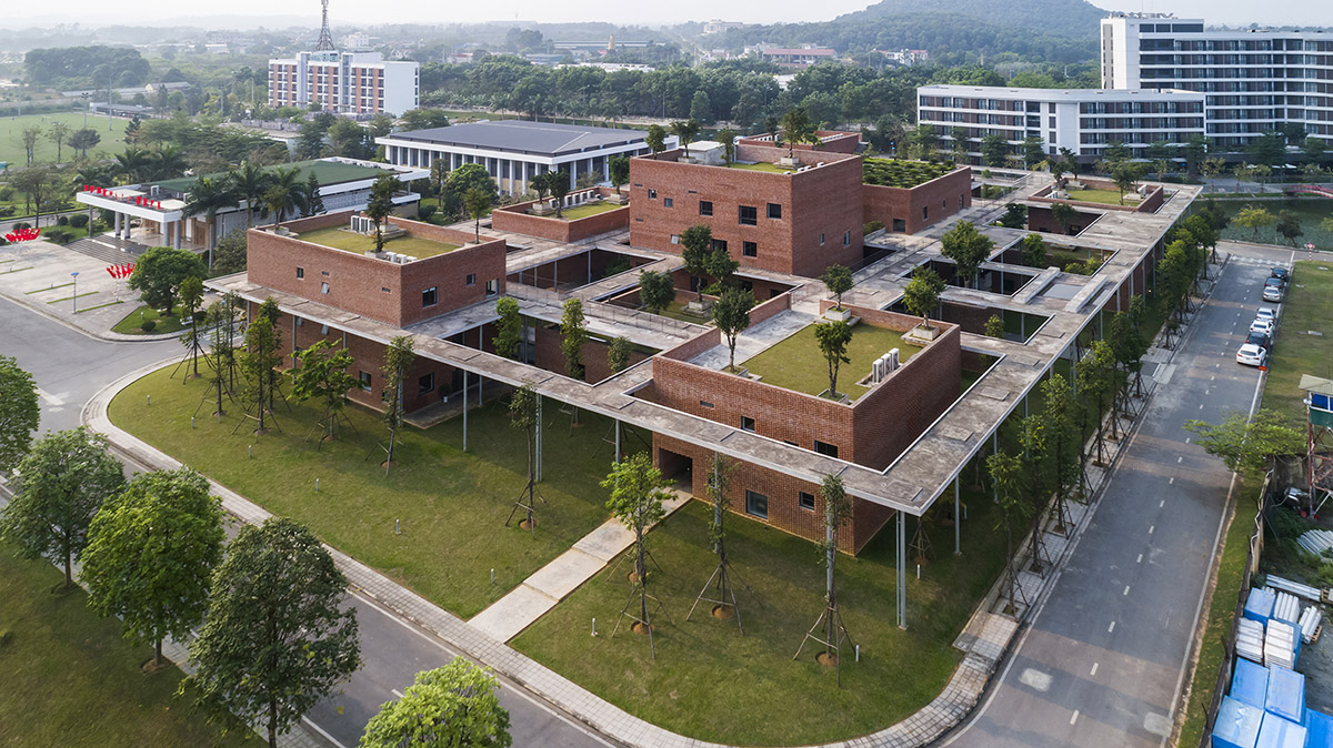 Multi-level circulation paths and gardens activate VTN Architects' Educational Center in Hanoi