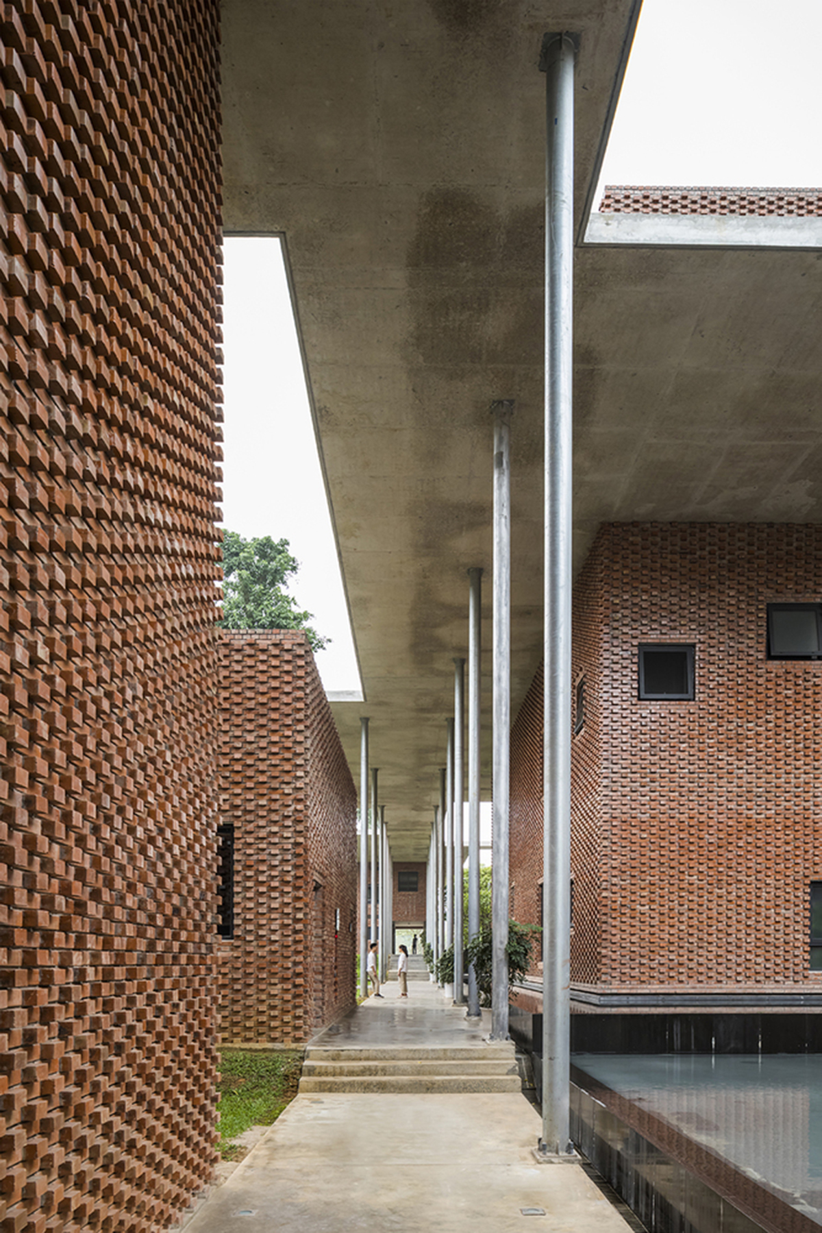Multi-level circulation paths and gardens activate VTN Architects' Educational Center in Hanoi