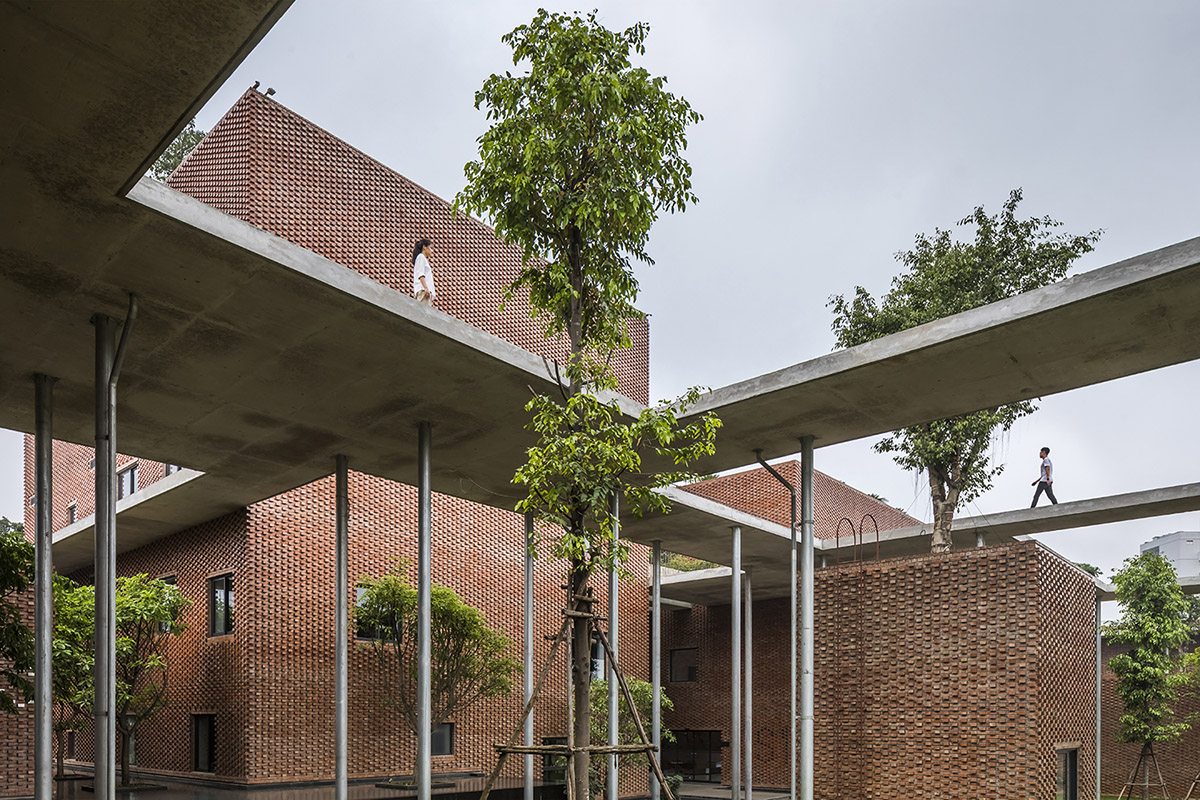Multi-level circulation paths and gardens activate VTN Architects' Educational Center in Hanoi