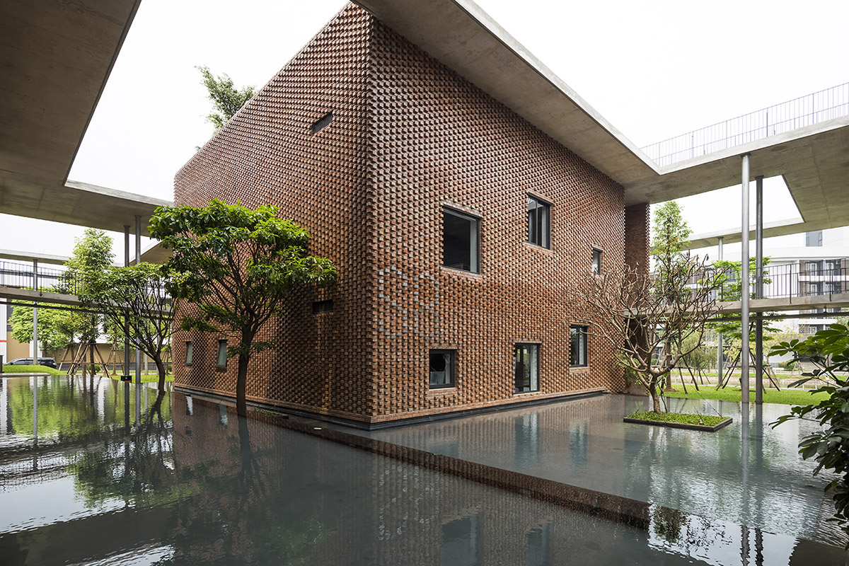 Multi-level circulation paths and gardens activate VTN Architects' Educational Center in Hanoi