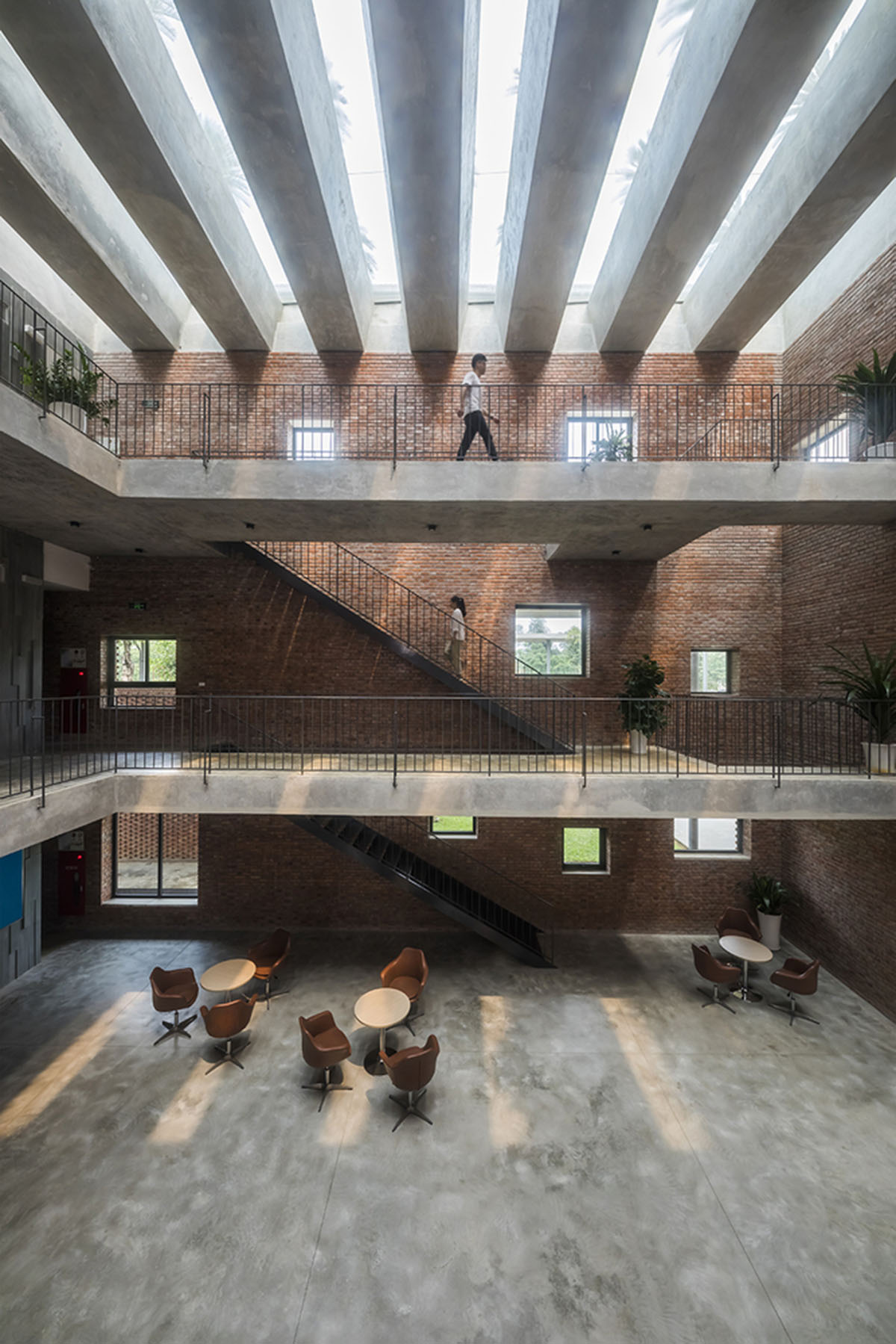 Multi-level circulation paths and gardens activate VTN Architects' Educational Center in Hanoi