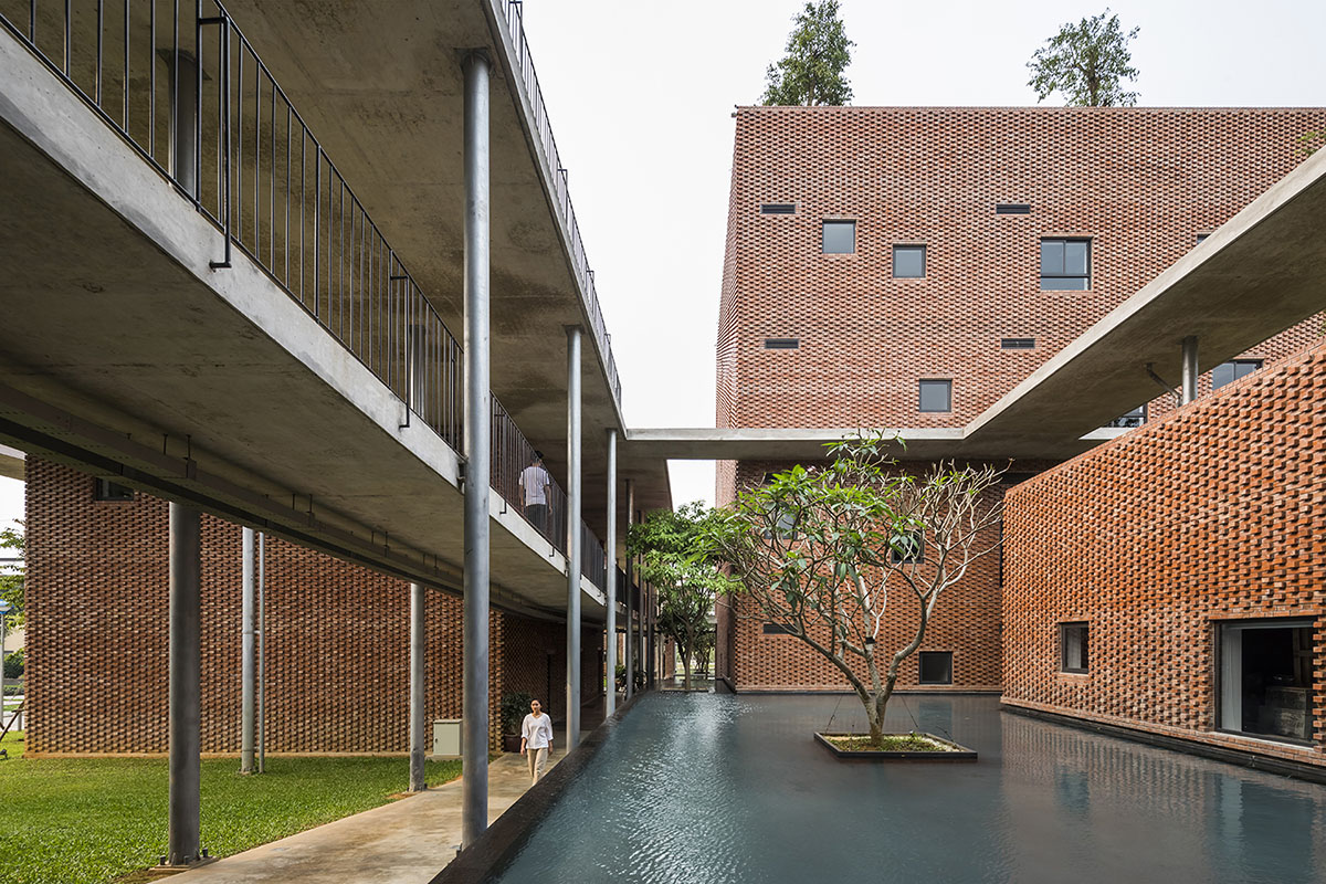 Multi-level circulation paths and gardens activate VTN Architects' Educational Center in Hanoi
