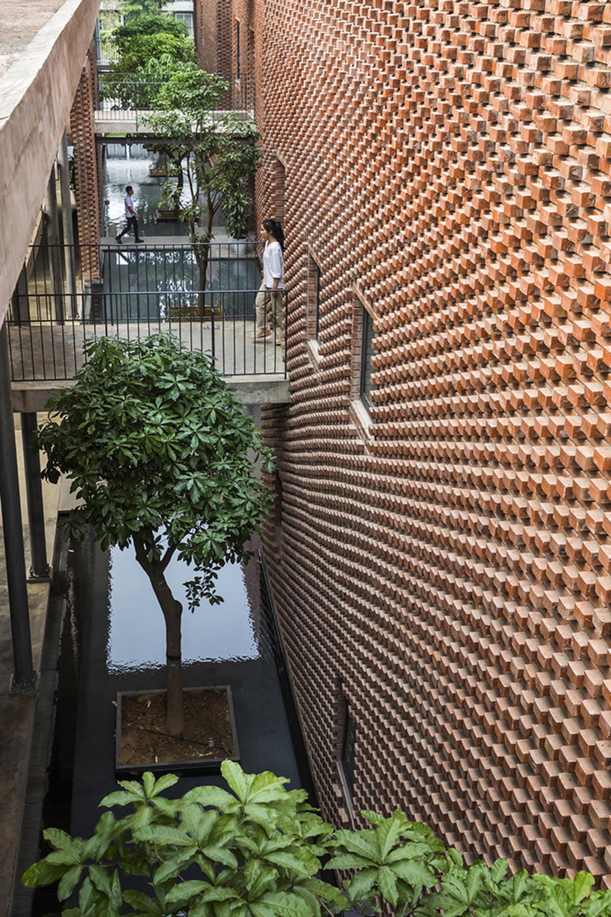 Multi-level circulation paths and gardens activate VTN Architects' Educational Center in Hanoi