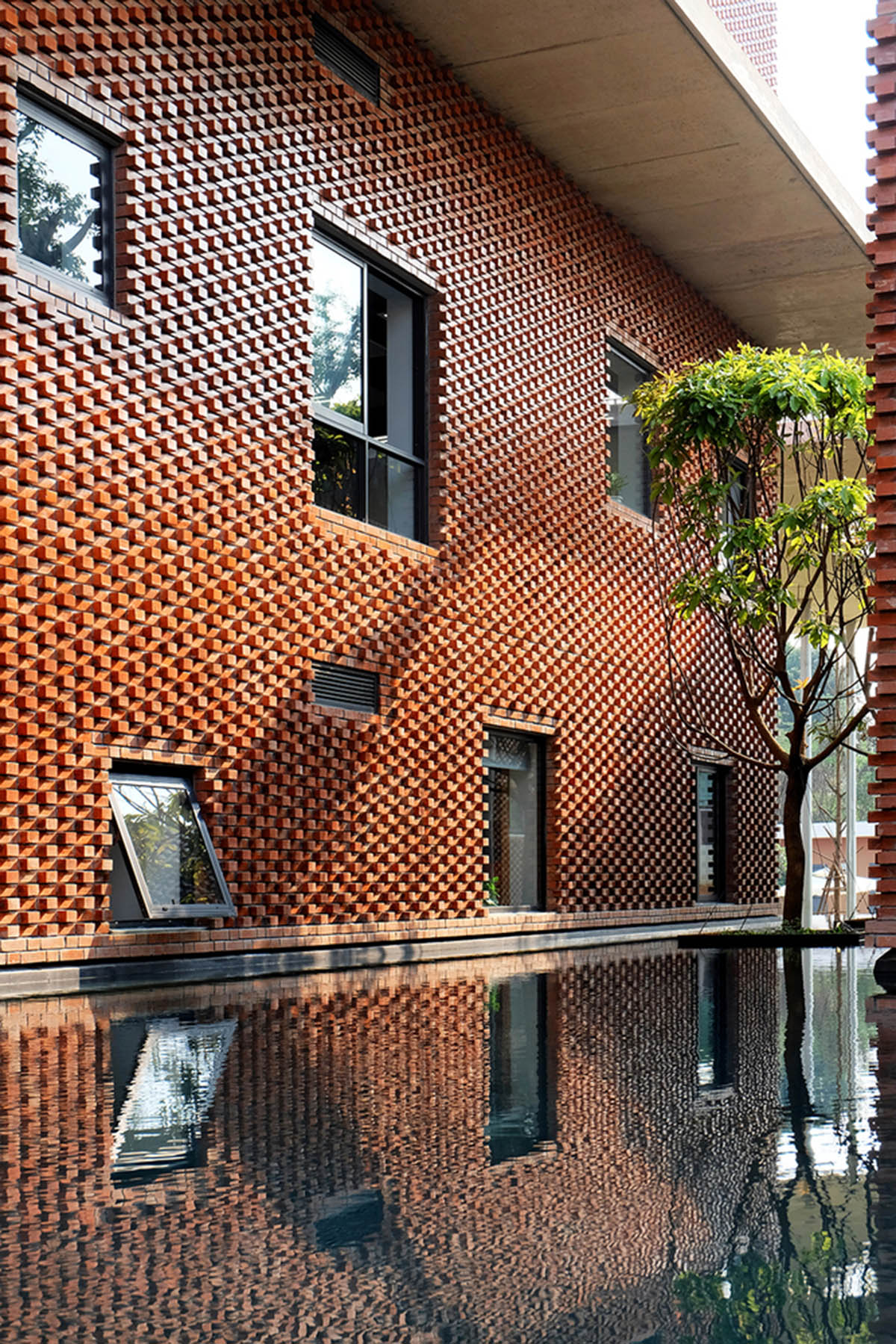 Multi-level circulation paths and gardens activate VTN Architects' Educational Center in Hanoi