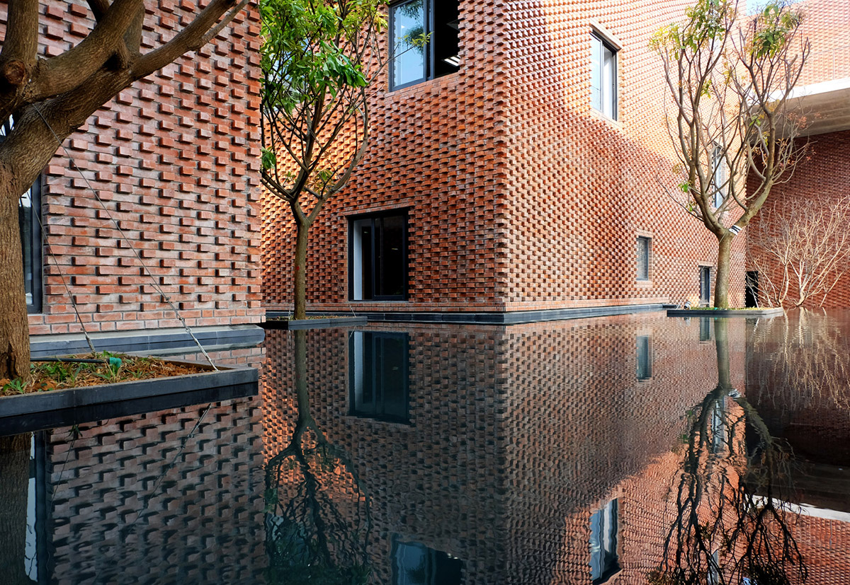 Multi-level circulation paths and gardens activate VTN Architects' Educational Center in Hanoi