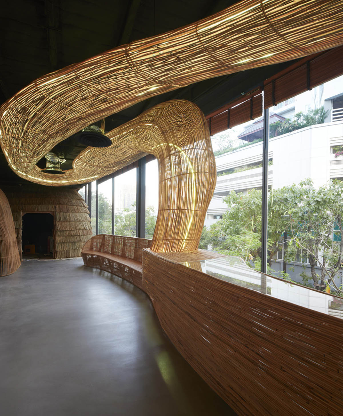 Free form wooden pods wrap the interior of yoga space in Bangkok designed by Enter Projects Asia