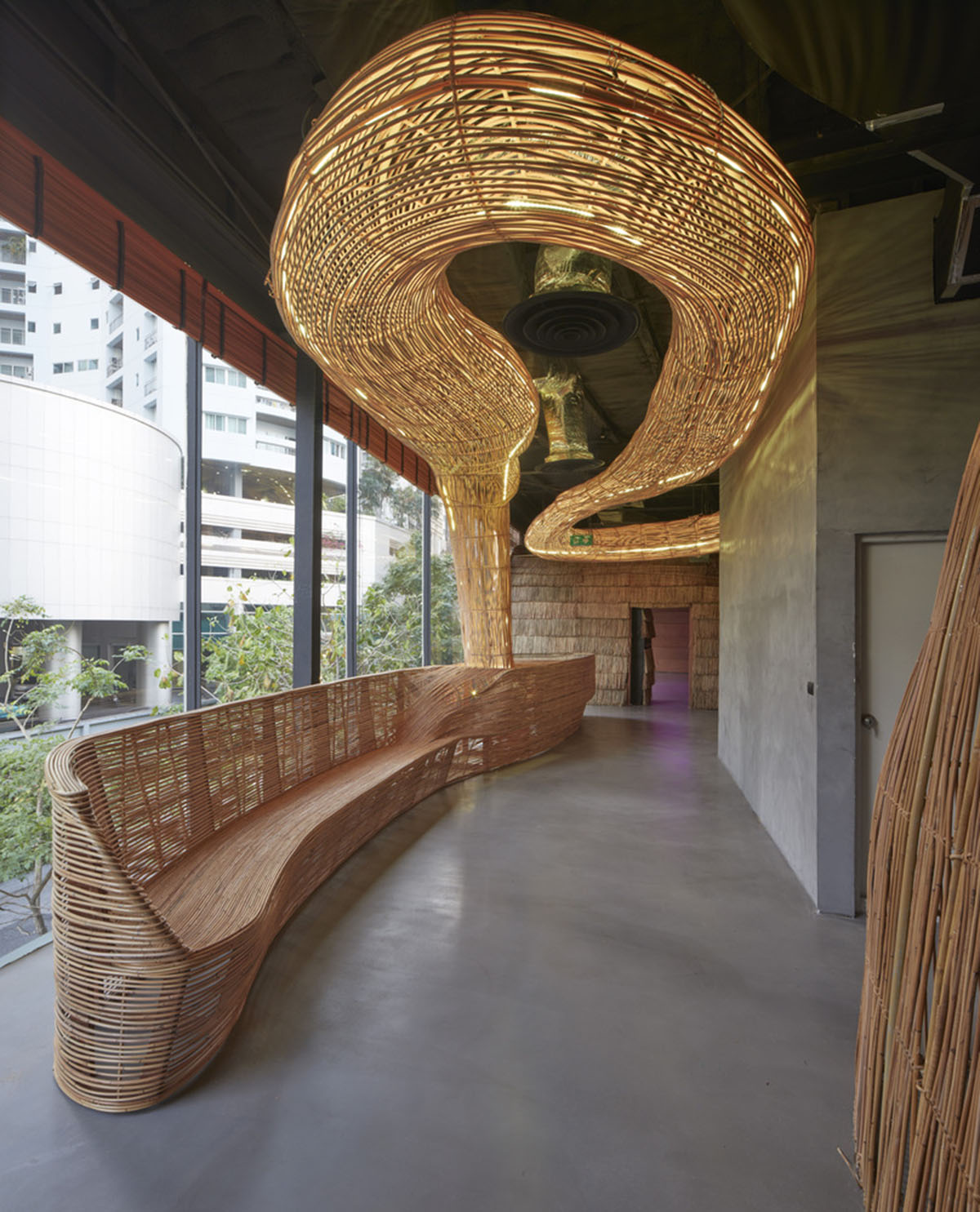 Free form wooden pods wrap the interior of yoga space in Bangkok designed by Enter Projects Asia